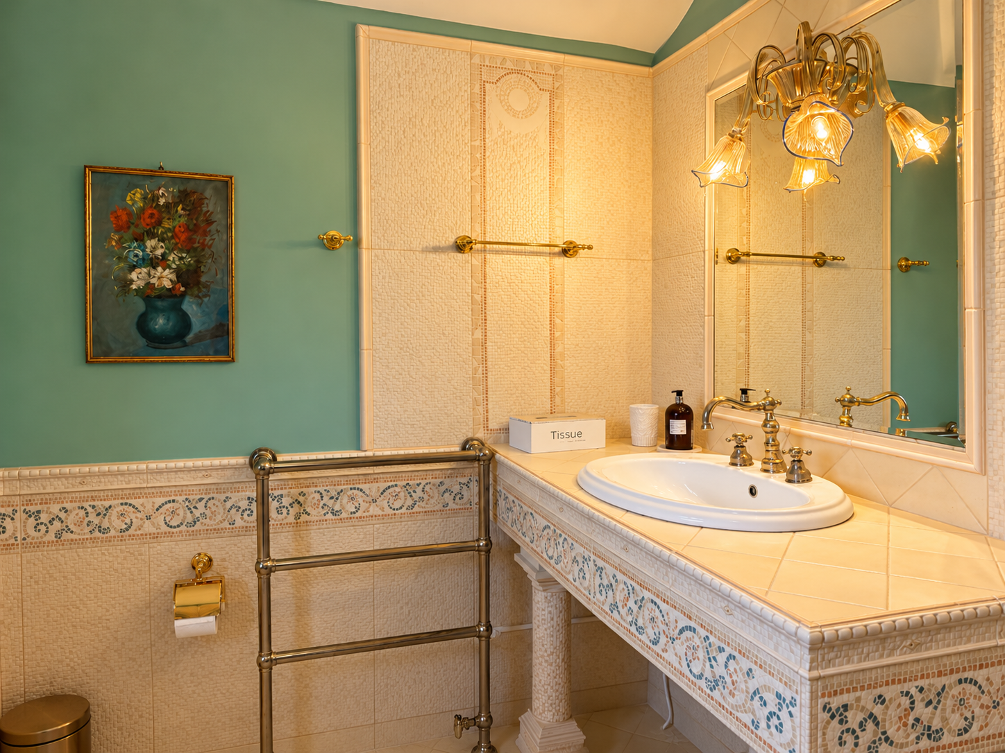 The Swedish Room vanity with a mosaic counter, gilded sconce and a large framed mirror